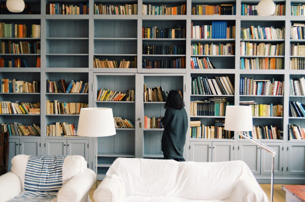 light blue built-in bookshelves behind a white couch