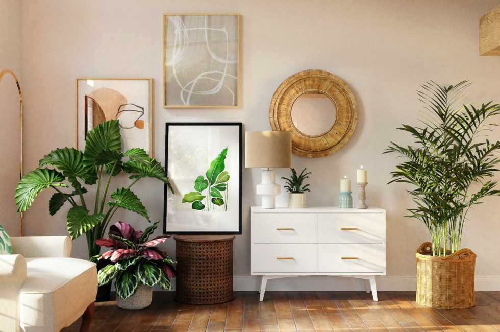 one of the Florida room ideas based on sunroom designs that features a white mid-century console, framed plant prints, circle rattan mirror, and large potted tropical plants