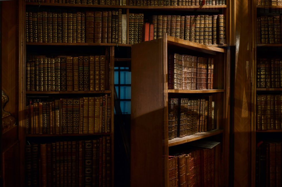 hidden door made to look like part of a wall-to-wall bookshelf